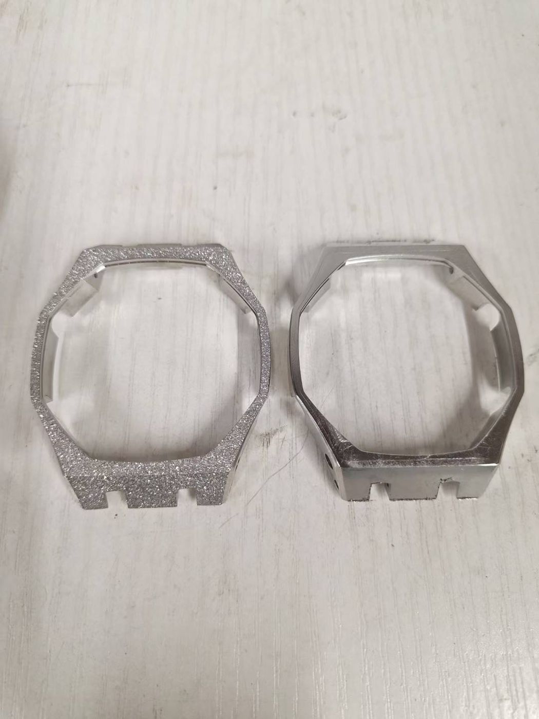 Watch case in sandblasted and polished finishes side by side